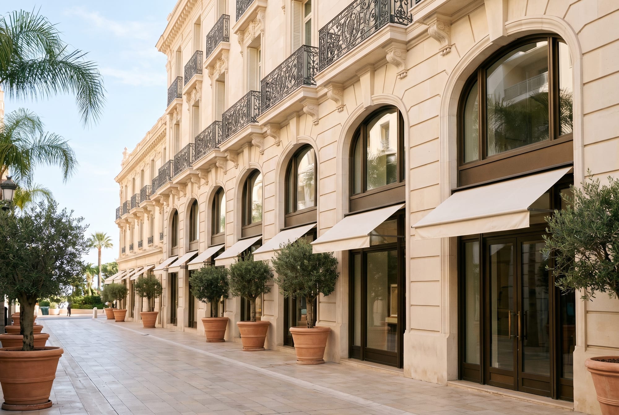 Pale stone façades and arched boutique windows on a quiet luxury retail street on the French Riviera